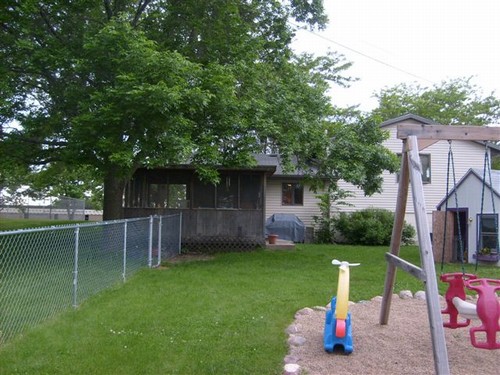 backyard nice play area, shed, patio, fence, and porch