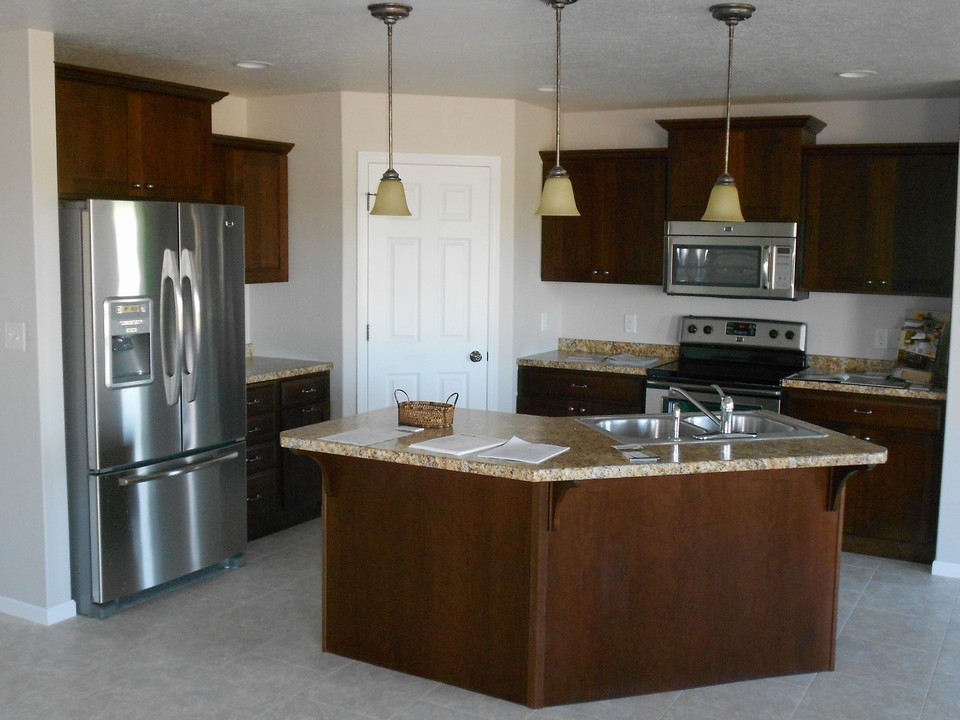 open kitchen maytag stainless steel appliances are included.  door leads to a corner pantry with shelves.